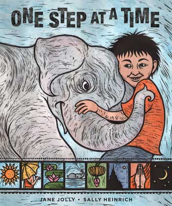 A boy embracing the trunk of a baby elephant on the cover
