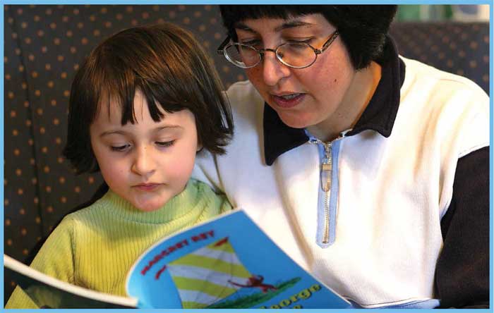 Adult and child reading together